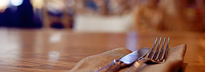 Knife and fork on napkin on counter
